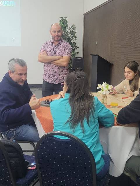 Un grupo de personas discutiendo en una mesa durante una reunión.