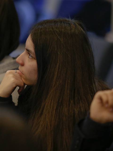 Un grupo de jóvenes escuchando atentamente durante una presentación.