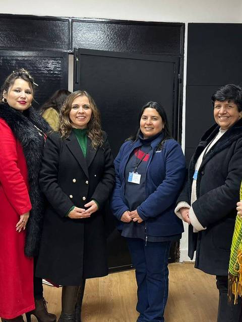 Grupo de seis mujeres posando juntas en un entorno interior.