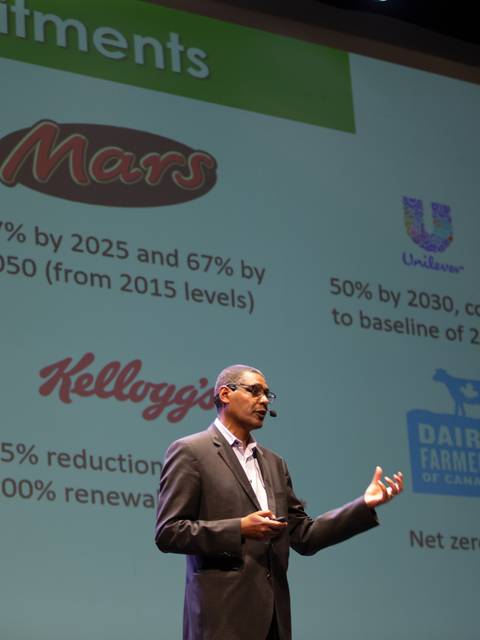 Un hombre presenta compromisos de sostenibilidad de diversas empresas durante una charla.