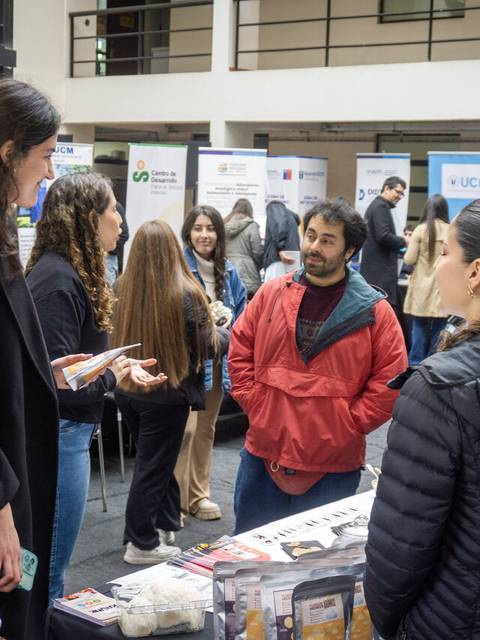 Un grupo de personas conversando en un evento en un edificio.