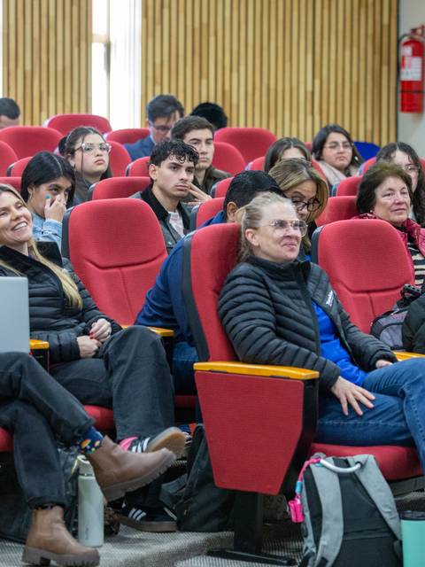 Una charla con un público atento en un auditorio.