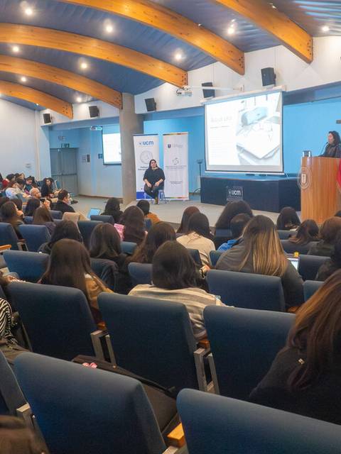 Una gran audiencia atenta a una presentación en un auditorio en Chile.