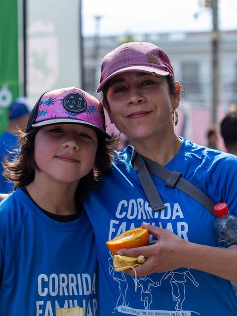 Mamá e hijo sonrientes en una corrida familiar.