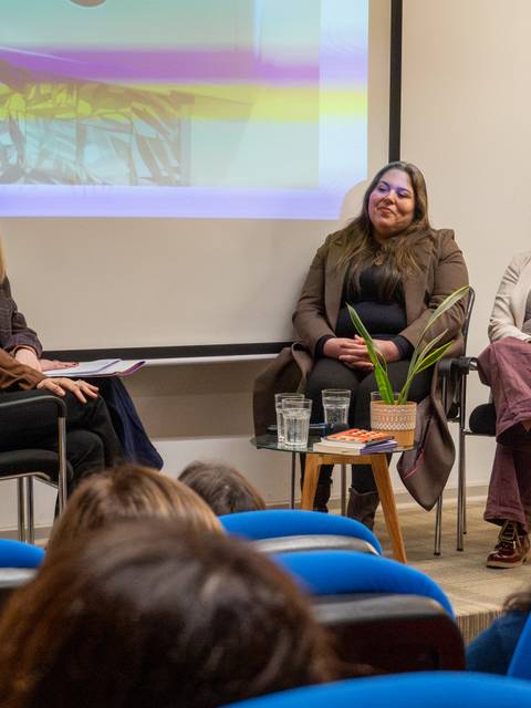 Una mesa redonda en la que varias mujeres conversan sobre temas de interés en un ambiente académico.