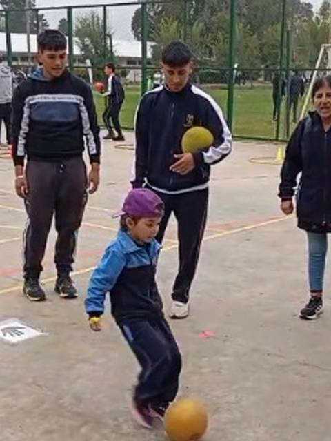 Un grupo de niños y adultos participa en una actividad deportiva en un colegio chileno.