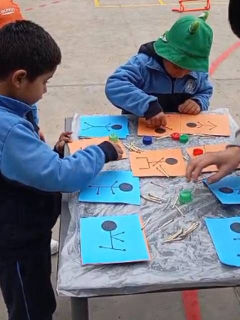 Niños en un taller artístico creando figuras con materiales diversos en la escuela.