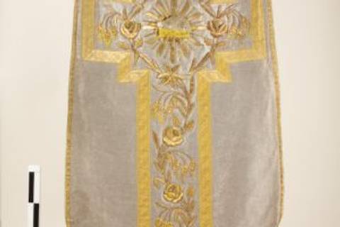 Una pieza textil decorada con bordados dorados y un diseño floral.