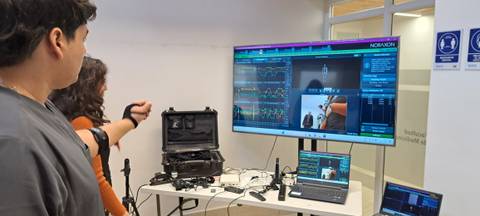 Un par de personas observando datos en una pantalla mientras trabajan con tecnología médica.