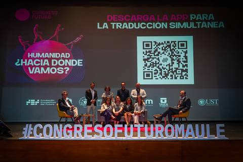 Un grupo de personas durante el Congreso Futuro en un escenario con una presentación sobre traducción simultánea.