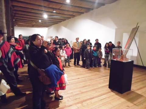 Un grupo de personas observa una obra de arte en un museo.