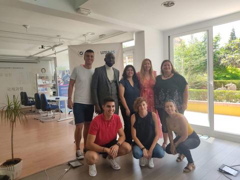 Grupo de personas posando en un ambiente de oficina iluminado por la luz natural.