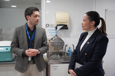 Dos personas conversando en un laboratorio.