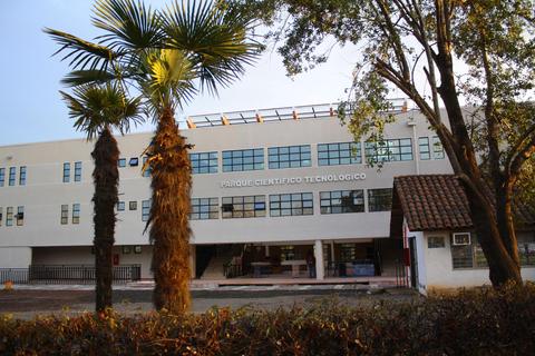 Edificio moderno del Parque Científico Tecnológico rodeado de palmeras.
