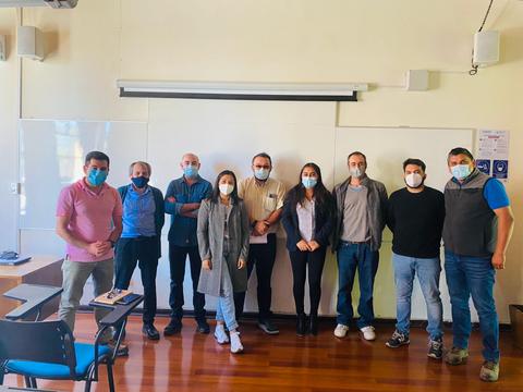 Grupo de personas en una sala con mascarillas debido a la pandemia.