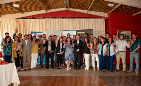 Grupo de personas posando juntas en un evento social con sonrisas y gestos amistosos.