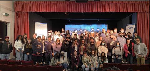 Un grupo grande de personas posando juntas en un escenario durante un evento.