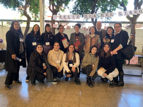 Un grupo de personas celebra el Día del Libro con sonrisas y una decoración festiva.