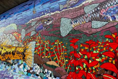 Un mural colorido que representa peces y plantas acuáticas en un entorno natural.