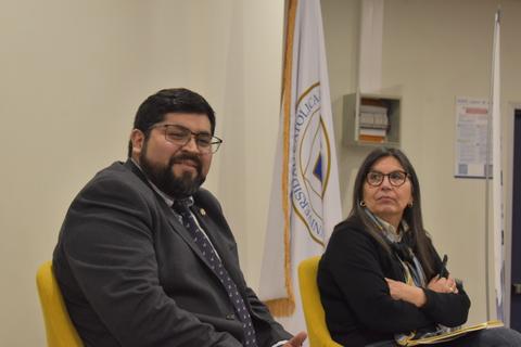 Un par de personas sentadas en una charla en una institución educativa en Chile.