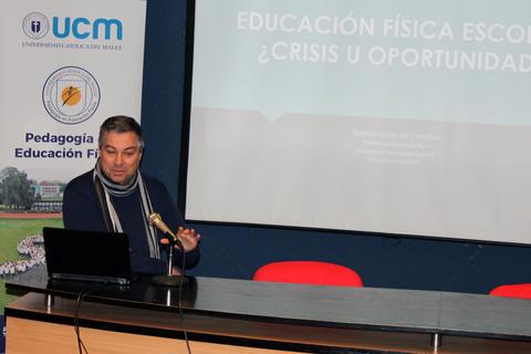 Un hombre presenta un tema sobre educación física en una conferencia.