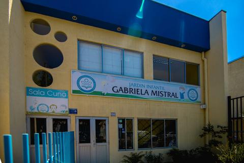 Edificio del Jardín Infantil Gabriela Mistral con una fachada color amarilla y ventanas grandes.