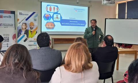 Un expositor presenta información en una reunión sobre temas laborales en Chile.