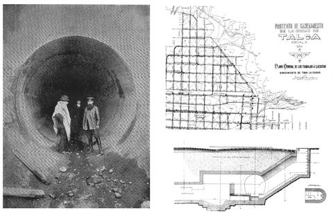 Tres hombres posan en la entrada de un túnel, rodeados de planos de construcción y un mapa.