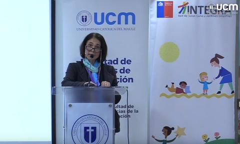 Una mujer habla en un evento académico en la Universidad Católica del Maule.