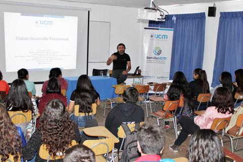 Un profesor está dando una charla a un grupo de estudiantes en un aula.