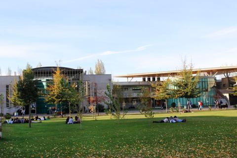 Imagen de un campus universitario con edificios modernos y zonas verdes.