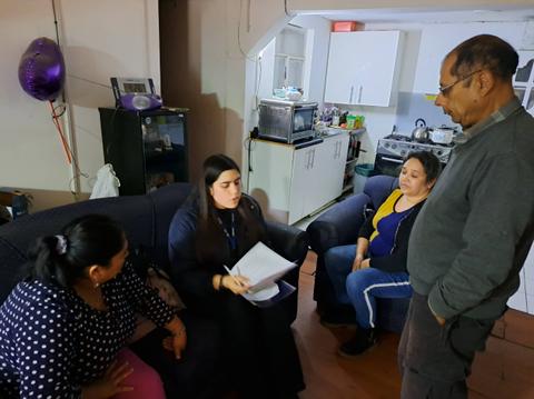 Un grupo de personas interactuando en una sala de estar.