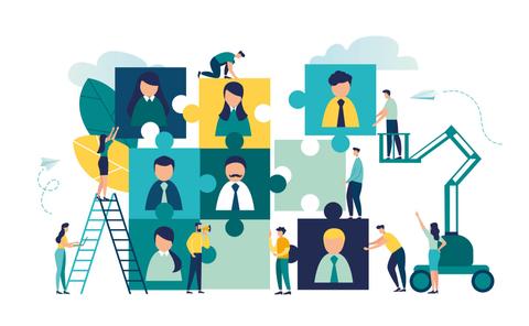Un grupo de personas trabaja en un rompecabezas que representa la colaboración en equipo.