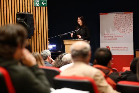 Una oradora presenta en un evento sobre desarrollo y crecimiento en innovación.