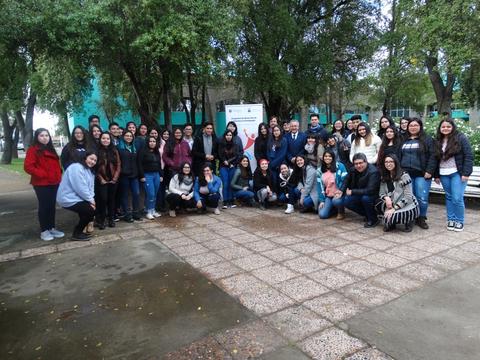 Un grupo grande de personas posando juntas en un ambiente al aire libre.