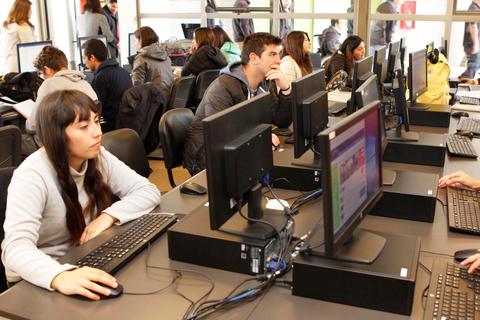 Un grupo de personas utilizando computadoras en un entorno de aprendizaje.