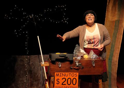 Una mujer está realizando una actuación teatral mientras vende algo en un escenario.