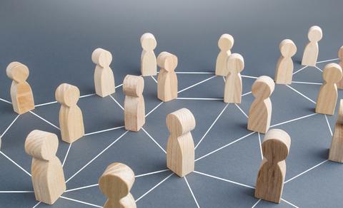 La imagen muestra figuras de madera dispuestas en una red conectada entre sí.