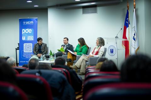 Una mesa panel con expositores hablando en un evento en Chile.