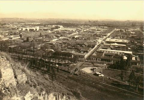 Vista panorámica de una ciudad con edificios y calles en un estilo antiguo.
