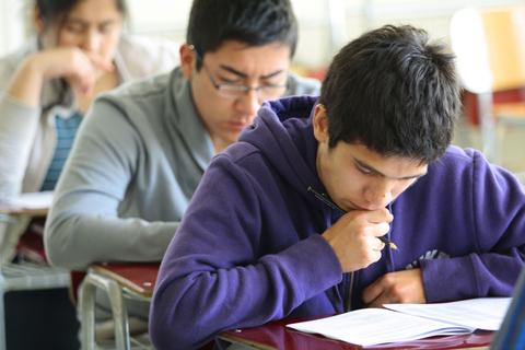 Un grupo de estudiantes concentrados en un examen en el aula.
