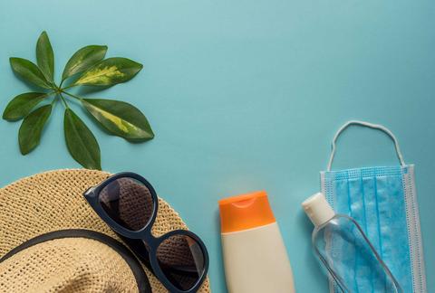 Elementos necesarios para un día de verano, incluyendo gafas de sol, protector solar y una mascarilla.