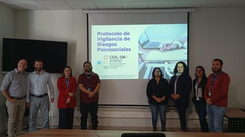 Equipo presentando el protocolo de vigilancia de riesgos psicosociales en una reunión.