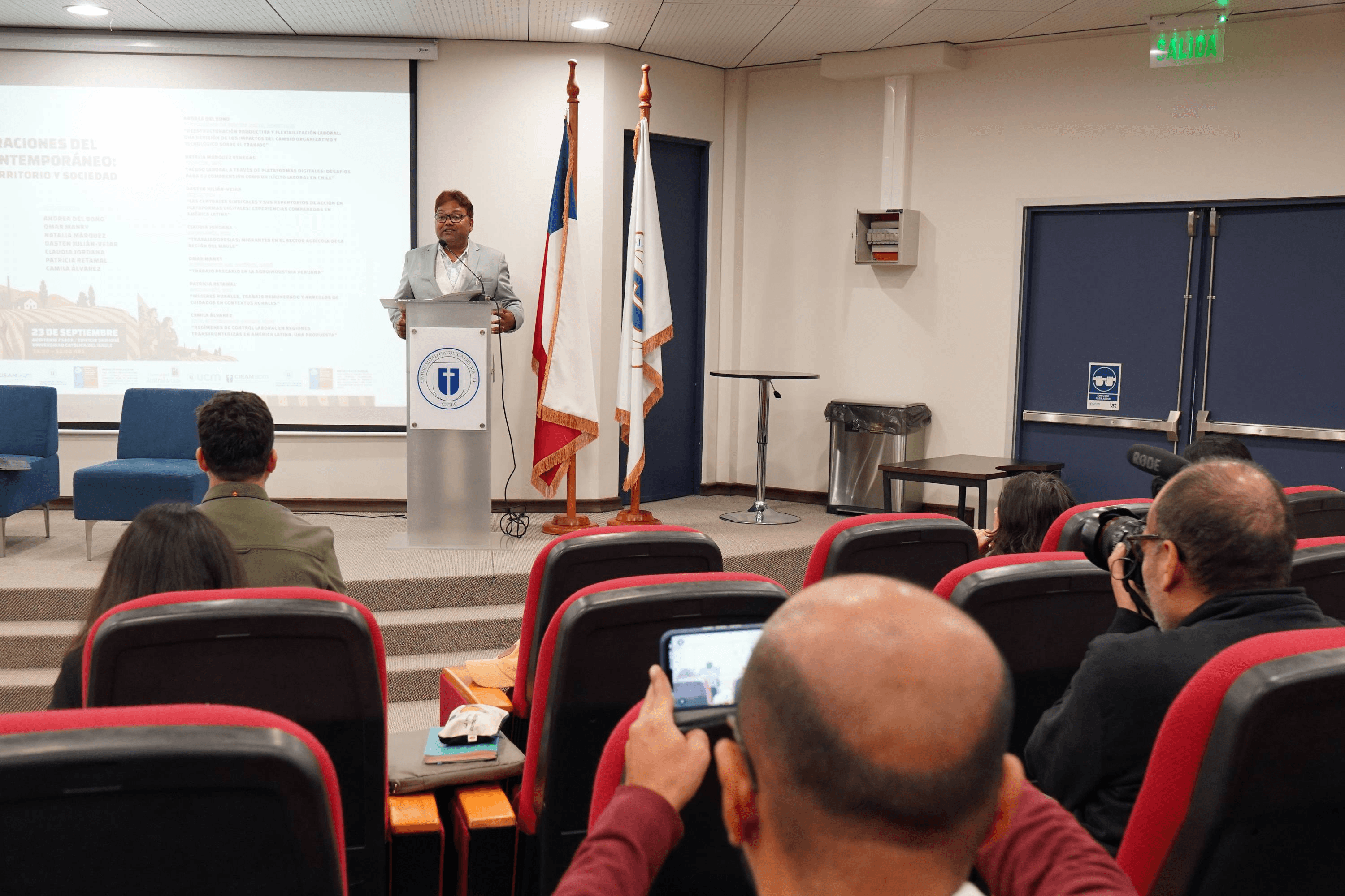 Un expositor habla frente a una audiencia en un evento en Chile.